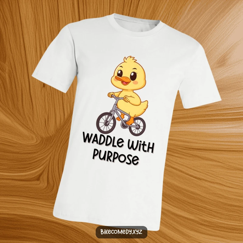 Funny duckling t-shirt depicting a happy, focused duckling pedaling a small bicycle with great enthusiasm and a determined spirit.