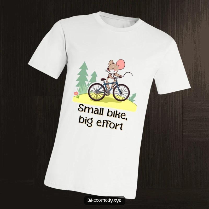 Funny mouse t-shirt depicting a courageous mouse straining to pedal a bicycle uphill, embodying grit and unwavering determination.